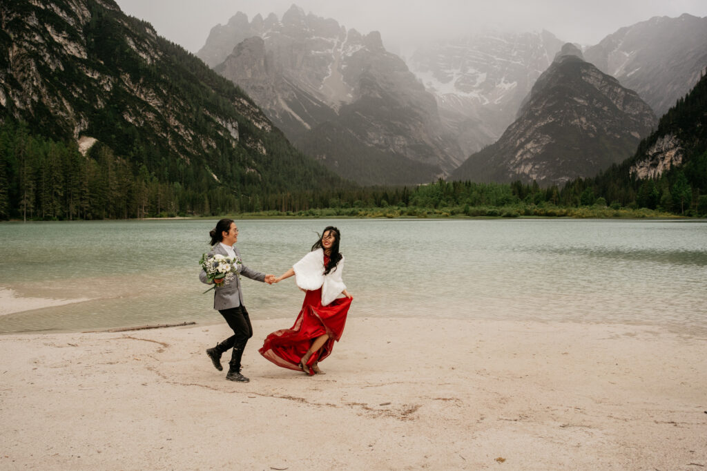 Couple holding hands by mountain lake