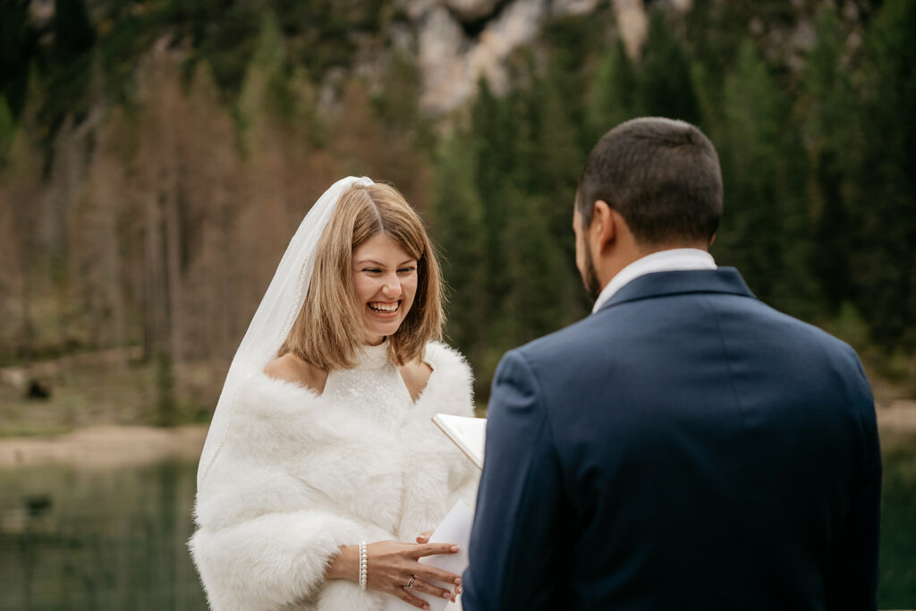 Bride and groom smiling during outdoor ceremony