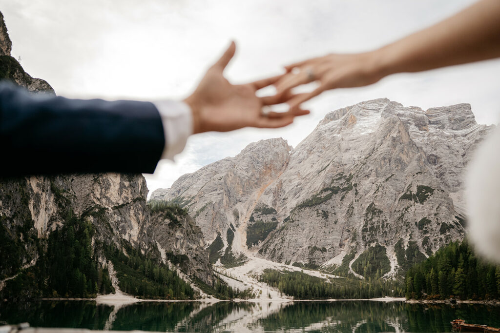 Hands reaching with mountain and lake background