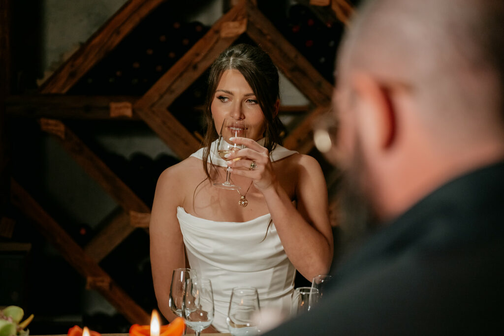 Woman in white dress drinking wine