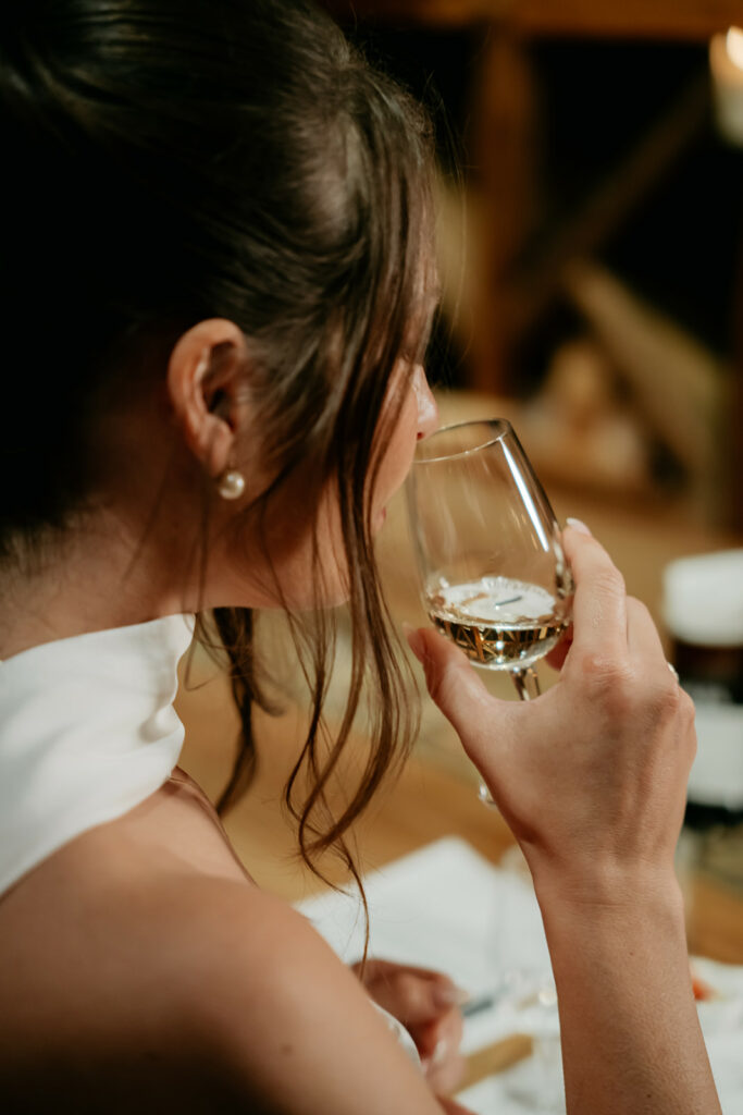 Woman sipping wine at elegant event