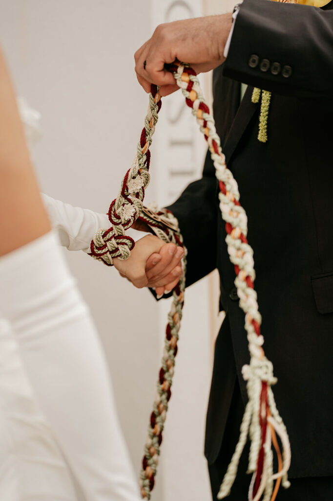 Hands bound with ceremonial cord at wedding