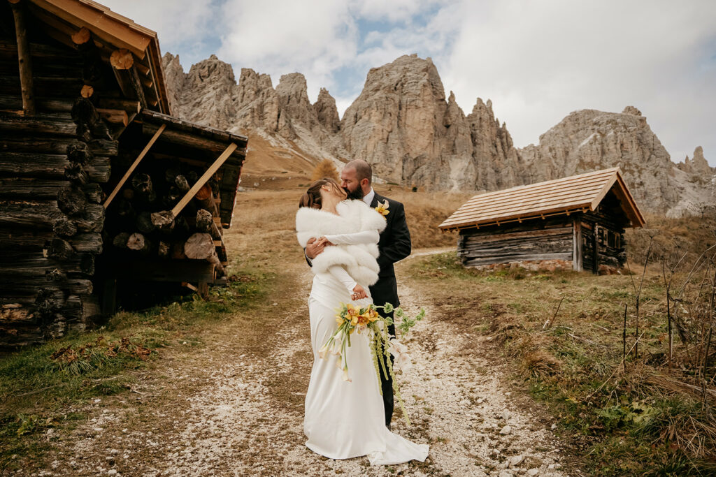 Bride and groom kissing in mountain setting