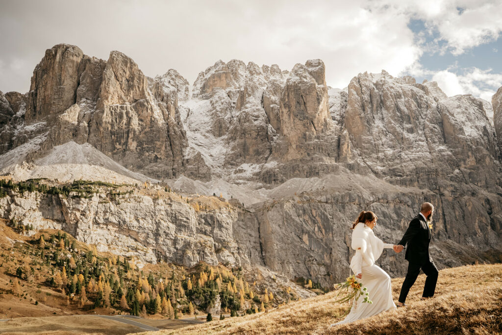Couple walking in mountains, scenic rocky landscape.