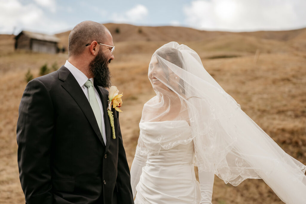 Bride and groom smiling outdoors