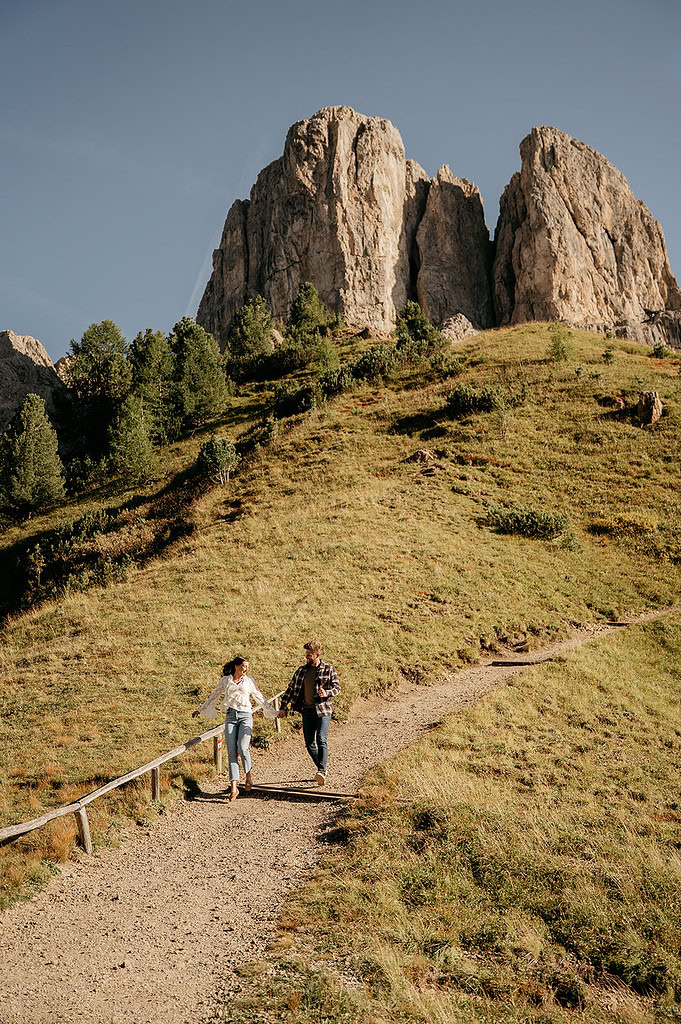 Couple hiking on scenic mountain trail.