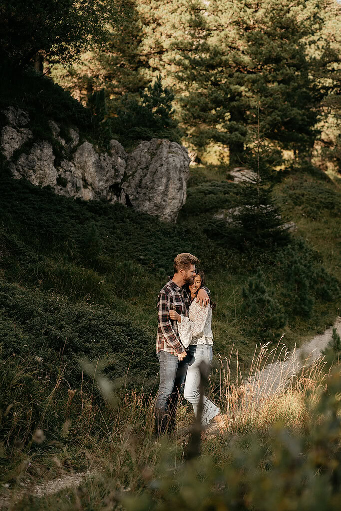 Couple hugging in forest meadow, romantic scenery.