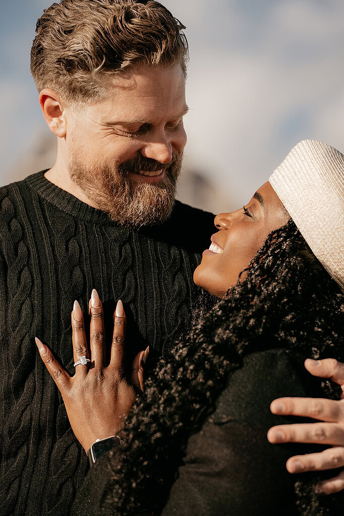 Happy couple embracing and smiling outdoors.