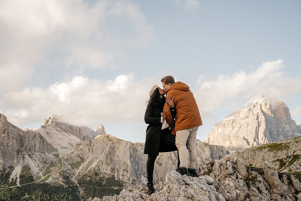 Couple kissing on a mountain peak