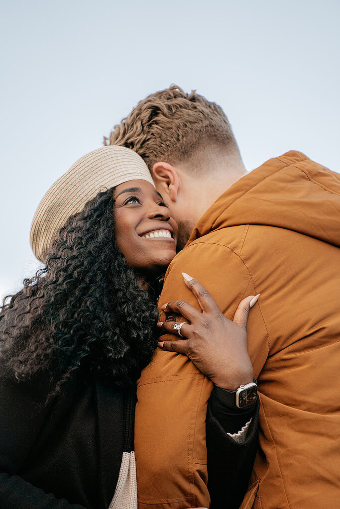 Smiling couple embracing outdoors