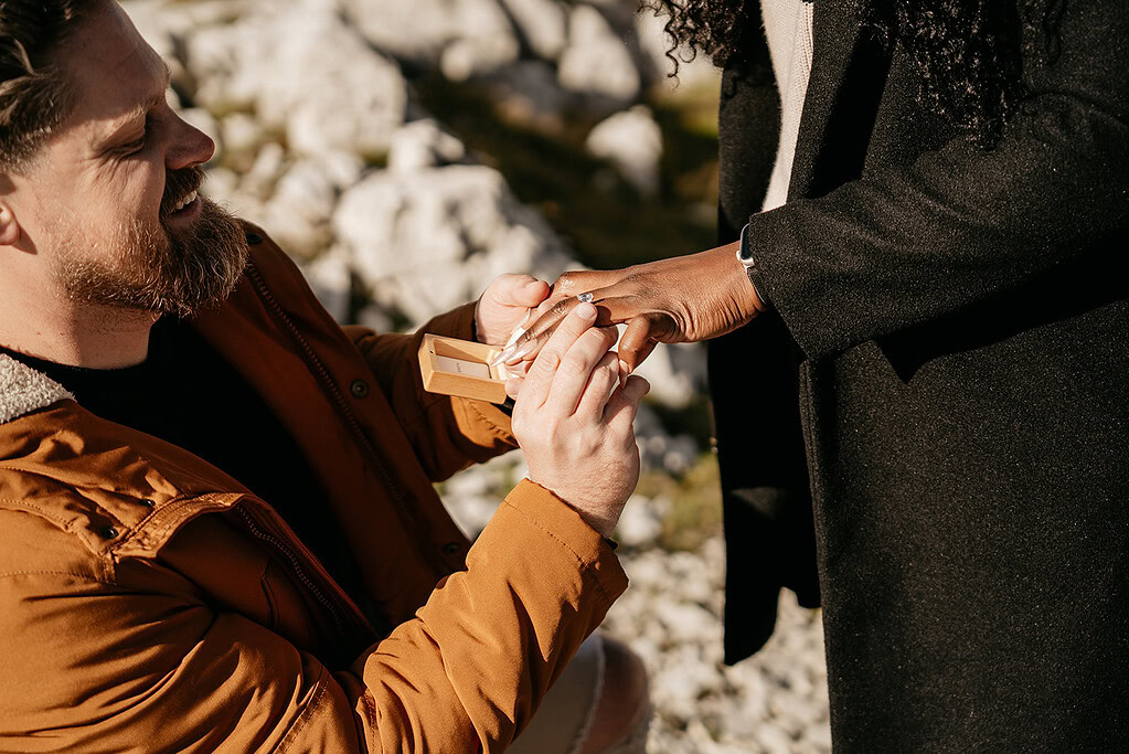 Man proposing with ring outdoors
