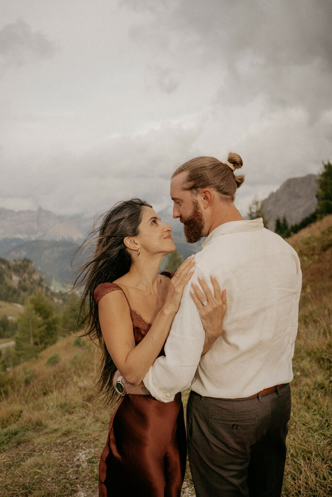 Couple embracing on a scenic mountain overlook.