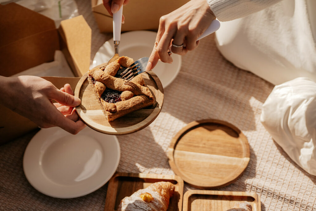 Two people sharing a slice of pie.
