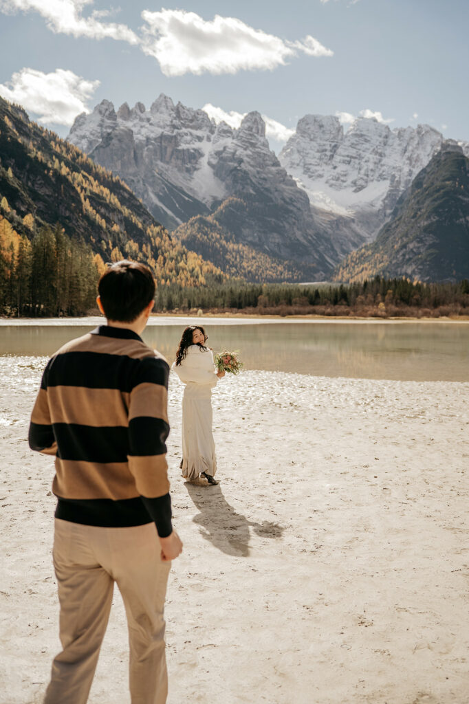 Couple by mountain lake, scenic view
