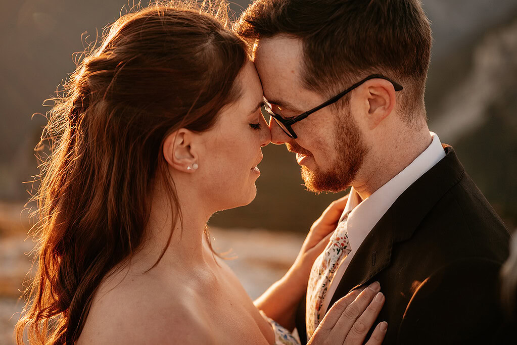 Couple embracing at sunset with closed eyes.