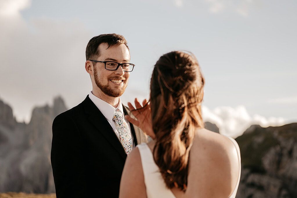Couple smiling during mountain wedding ceremony.