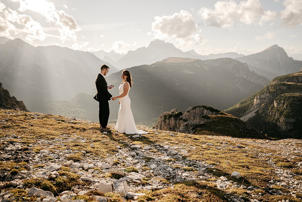 Couple exchanging vows on a mountain cliff.