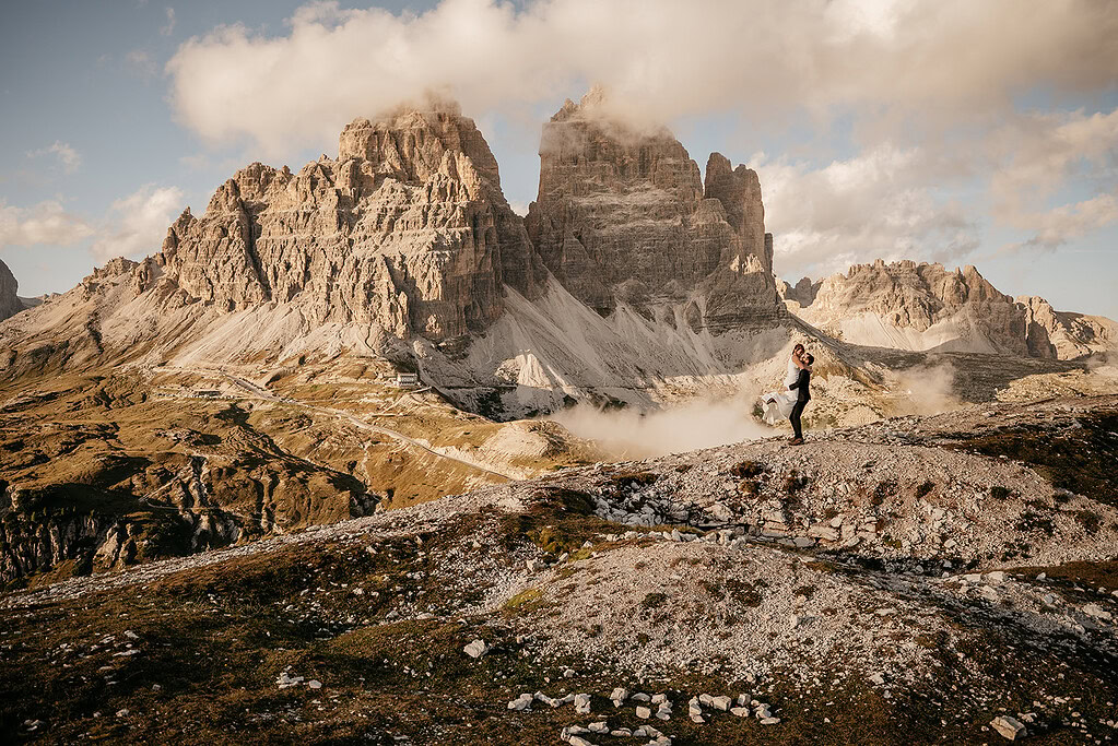 Couple embracing, mountains in background