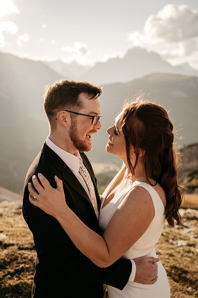 Happy couple embracing with scenic mountain backdrop.