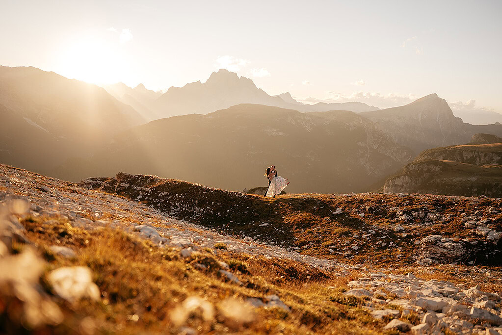 Couple elopes in mountain sunset landscape