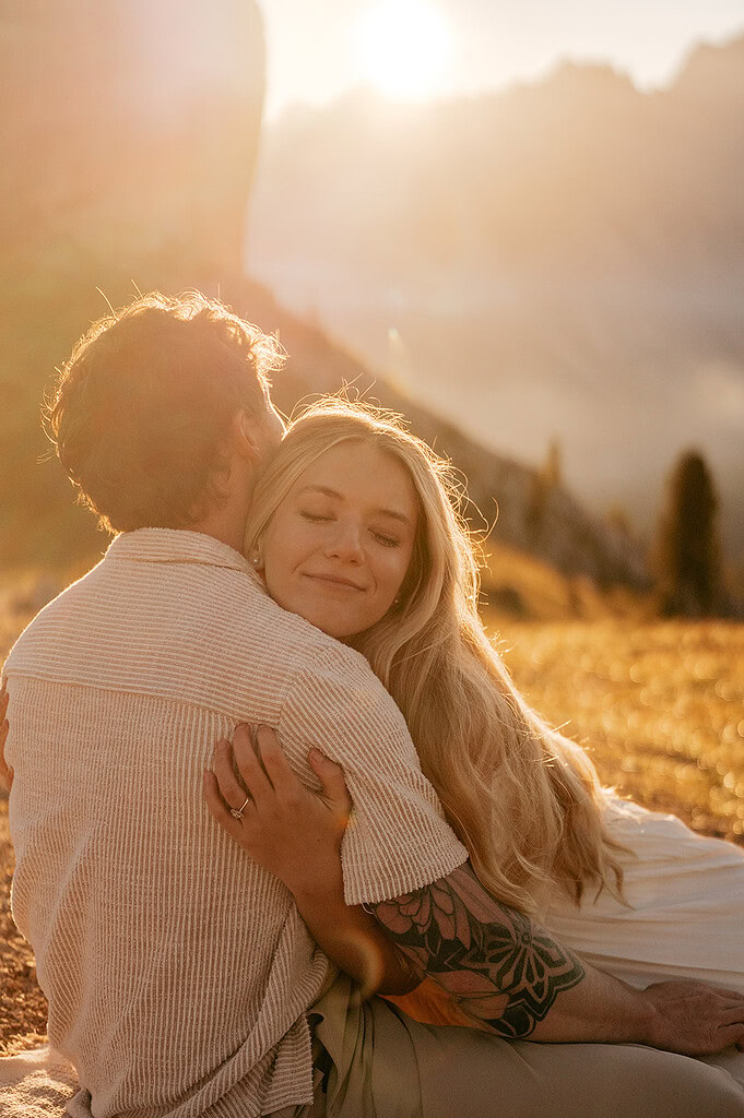 Couple embracing at sunset in scenic mountain area