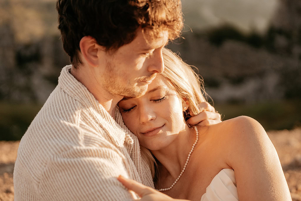 Couple embracing softly in warm sunlight