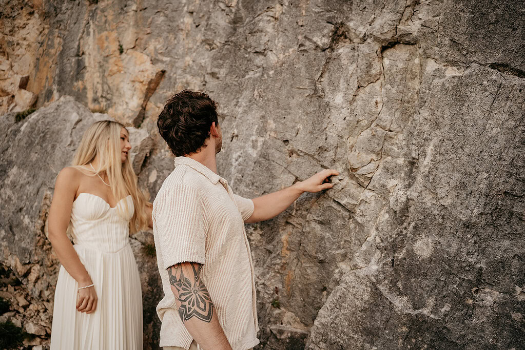 Couple exploring rocky cliff