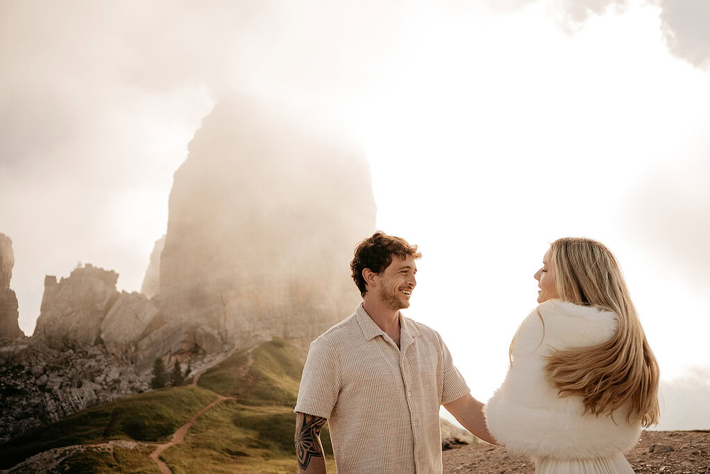 Smiling couple in front of misty mountain landscape