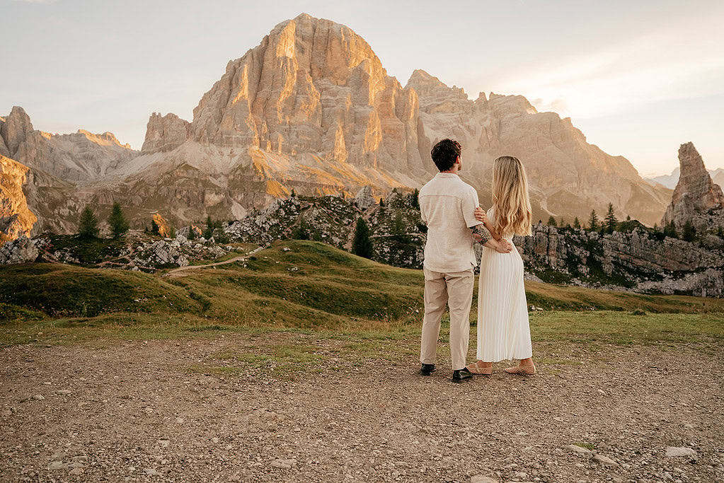 Couple enjoying mountain view at sunset.