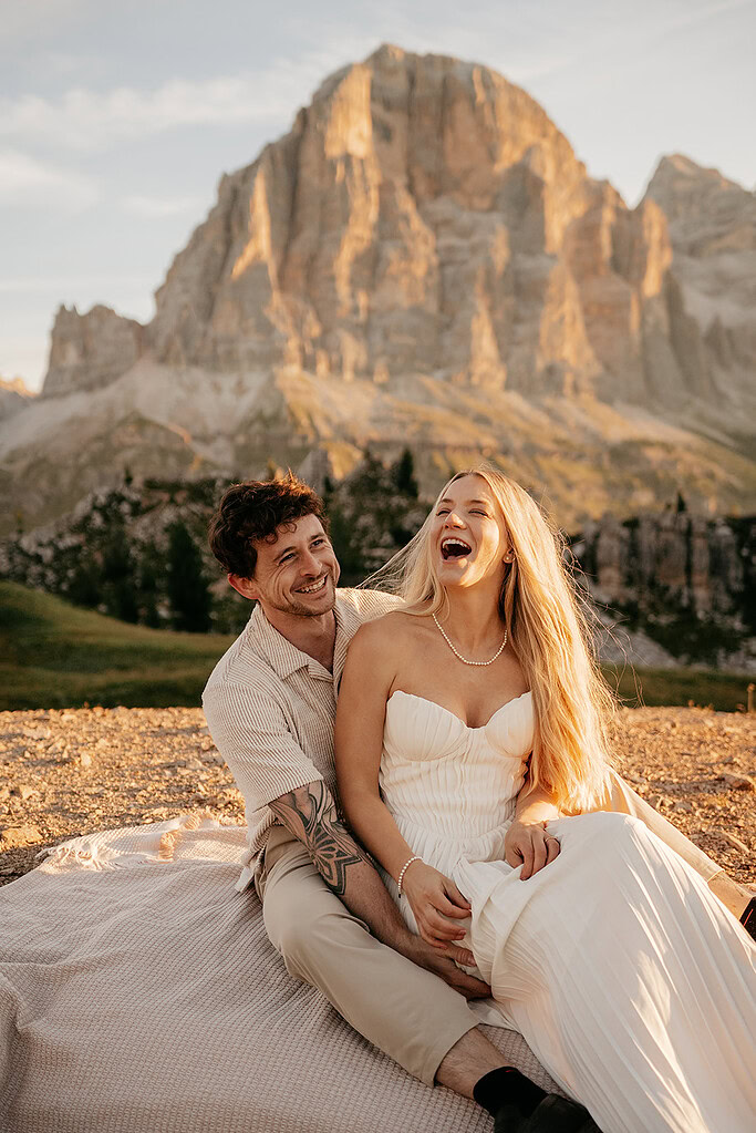 Couple laughing together in mountain landscape