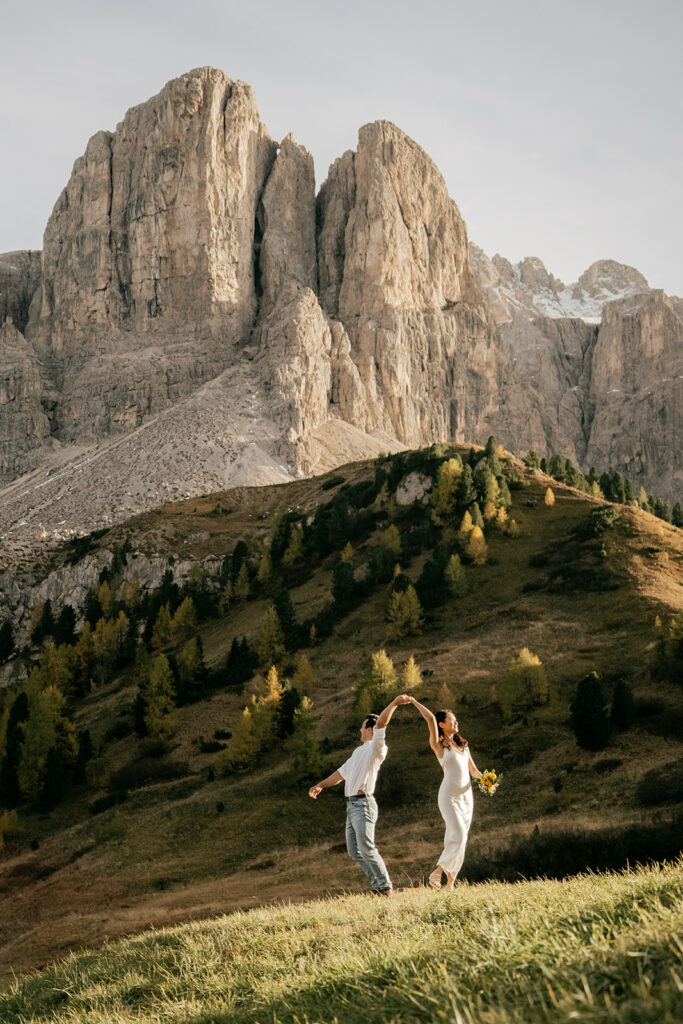 Couple dancing in front of scenic mountain backdrop