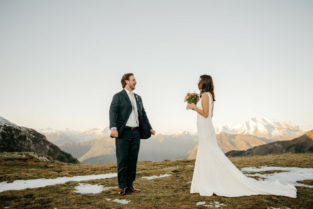 Bride and groom in snowy mountain landscape