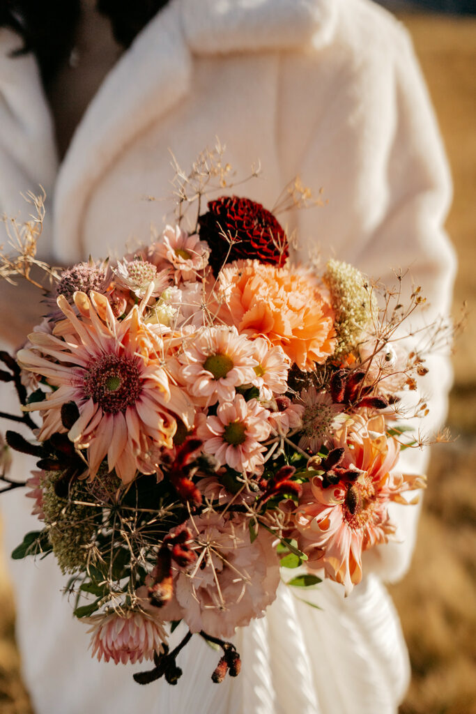 Bride holding rustic autumn flower bouquet