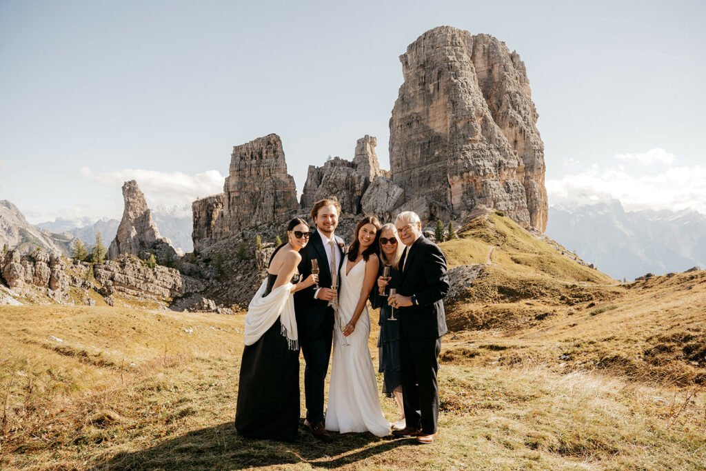 Group celebrating in mountain landscape.
