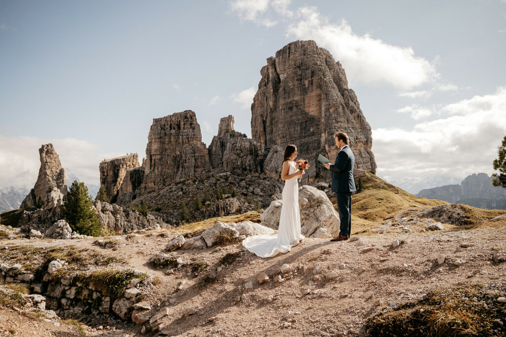 Couple exchanges vows in mountain wedding ceremony.