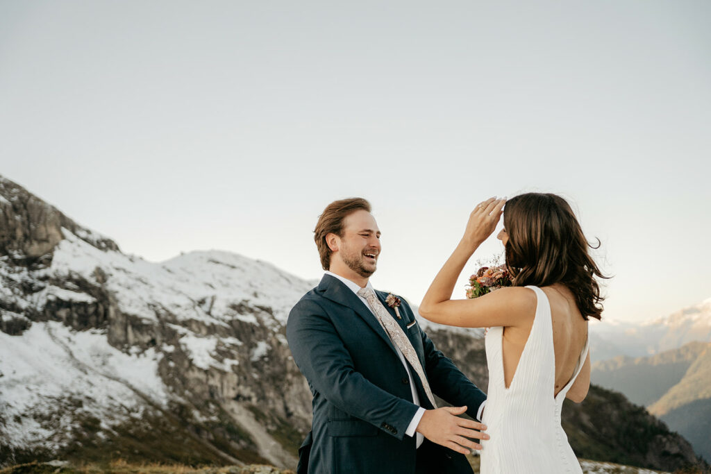 Happy couple celebrating outdoors in snowy mountains.