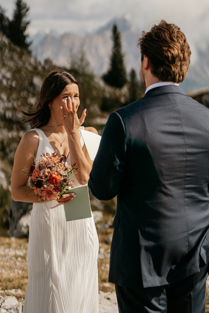 Bride crying during outdoor wedding ceremony