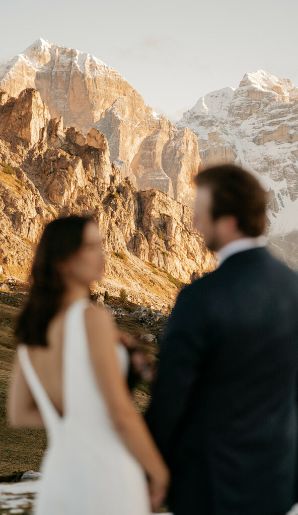 Couple at sunset with mountain backdrop.