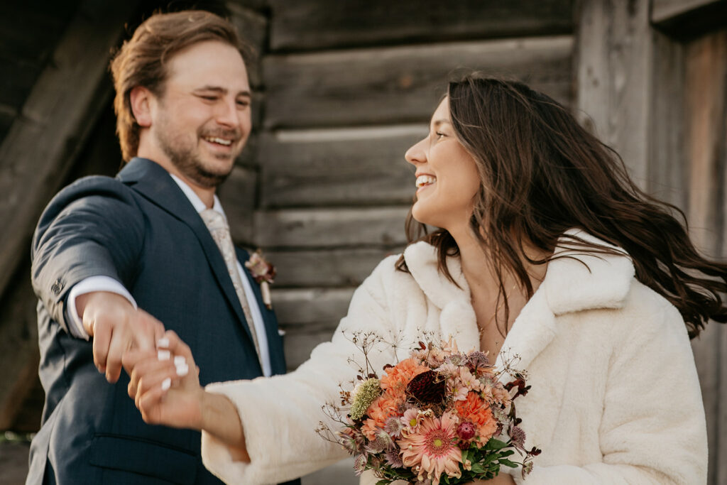 Couple dancing joyfully at rustic wedding