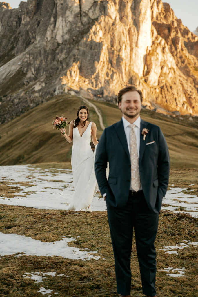 Bride and groom in snowy mountain landscape
