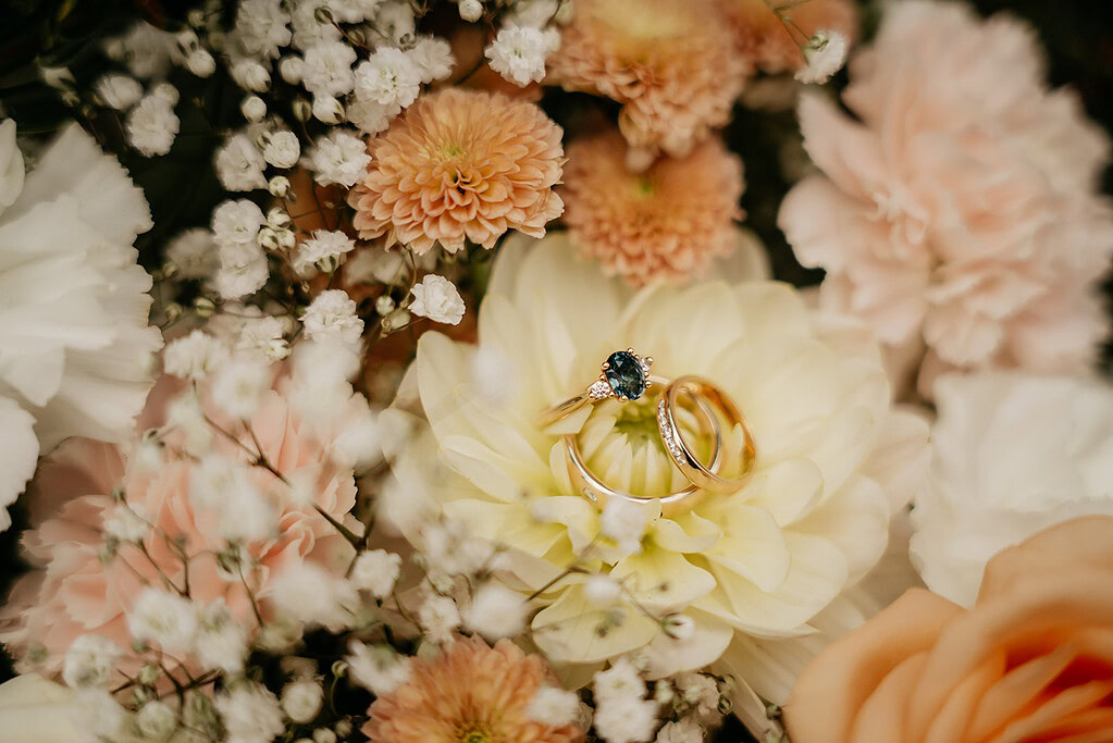 Wedding rings on flowers with baby's breath.