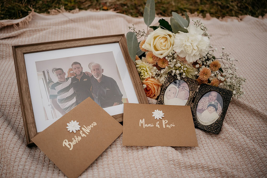 Family photos and flowers on blanket.