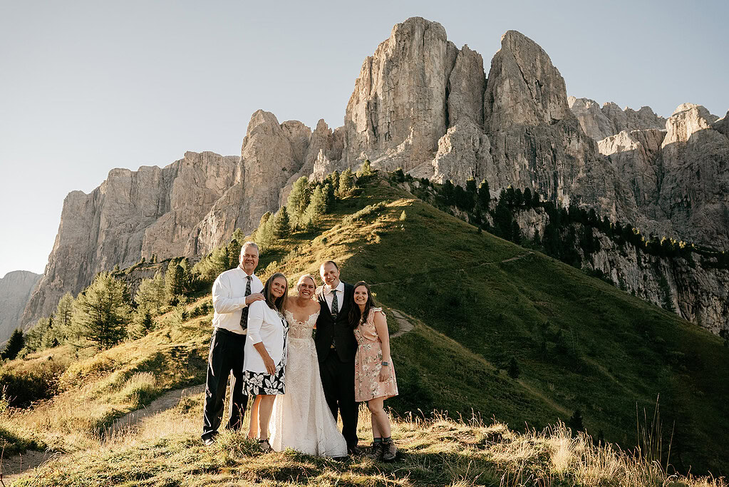 Group smiling in front of mountain landscape.