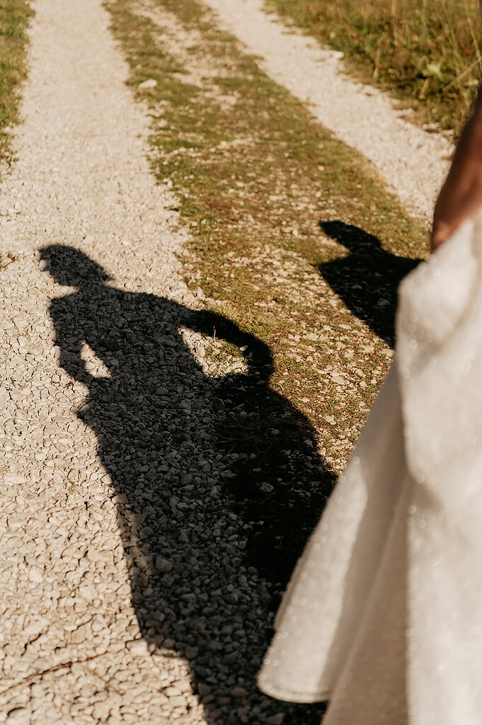 Bride's shadow on gravel path
